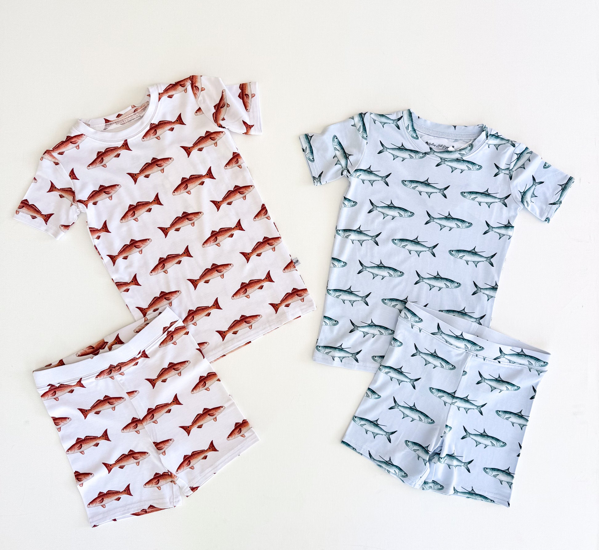 White two-piece short sleeve and Shorts, pajamas with red fish and light blue shorts and short sleeve pajamas with tarpon