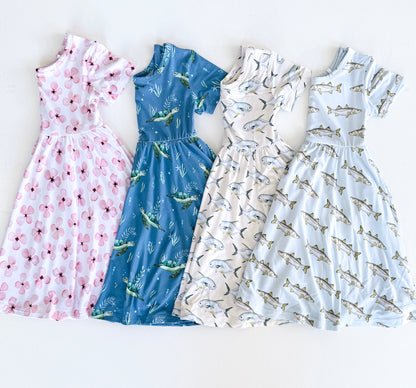 Four dresses with different patterns on a white background