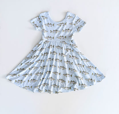 Children's dress with Snook pattern on a light blue background