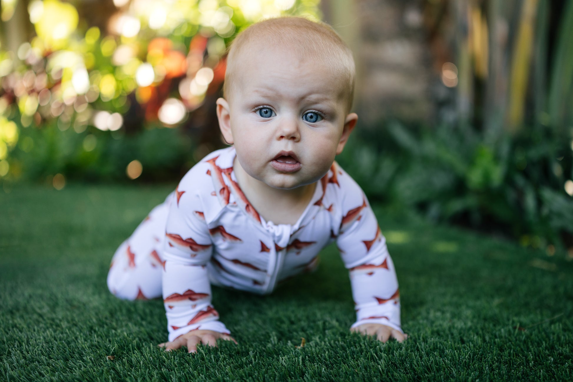 baby crawling in her redfish zippy