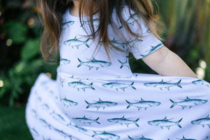 close up of a little girl stretching the tarpon seaside dress