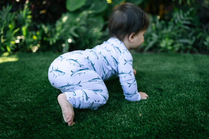 baby crawling on turff in a tarpon zippy
