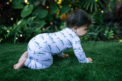 Baby crawling on turff in a tarpon zippy