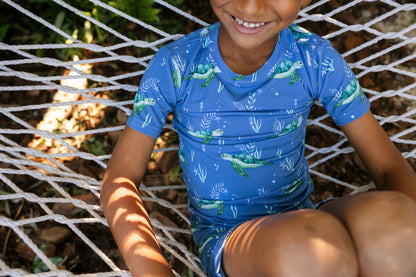 Close-up picture of short sleeve pajamas with blue background and sea turtles