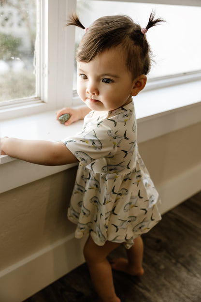 And standing in a windowsill wearing yellow ruffle, peplum and bloomers with permit on it