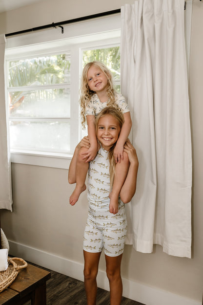 Two little girls on shoulders wearing and permit pajamas