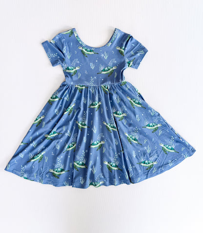 Blue dress with sea turtle pattern on a white background