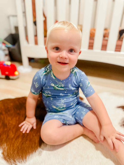 Customer provided picture of a little boy wearing the blue sea turtle short sleeve pajama