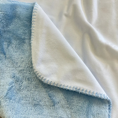 White minky blanket closeup with light blue sherpa backing 