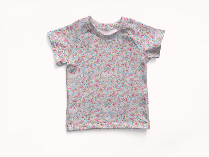 Floral patterned short sleeve rashguard swim shirt on a white background